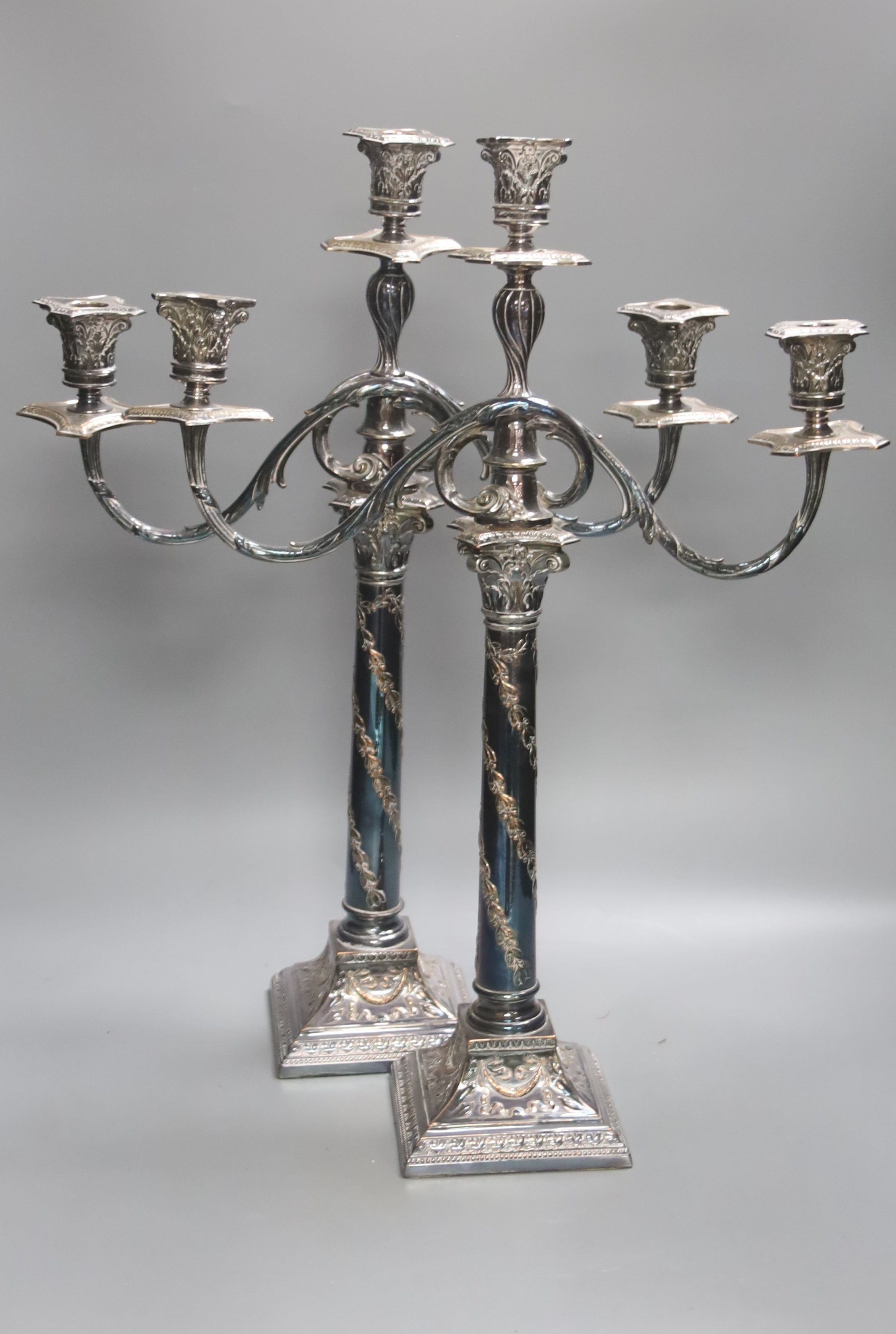 A pair of Georgian style plated two-branch three-light candelabra, height 53cm